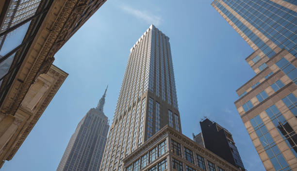 istock New York, Manhattan. High buildings view from below against blue sky background 1155854134