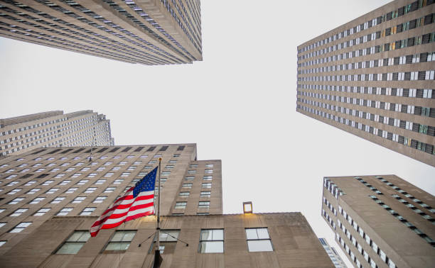 istock New York, Manhattan. High buildings view from below against blue sky background 1155854156