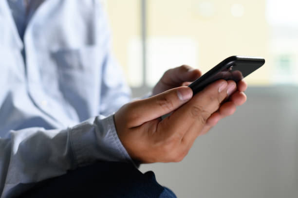 istock Close-up Young man with smartphone work and talking on the phone 1155855577