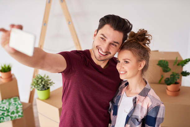 istock Great selfie of smiling couple in their new home 1155856607