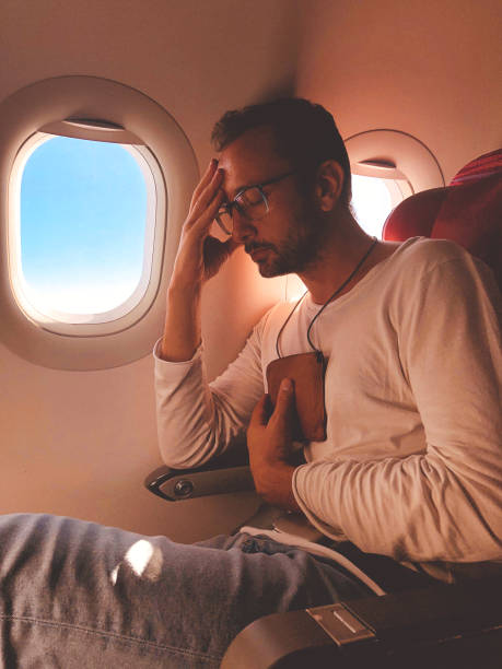 istock Airplane passenger with a neck bag for safe carrying money and documents. 1155856612