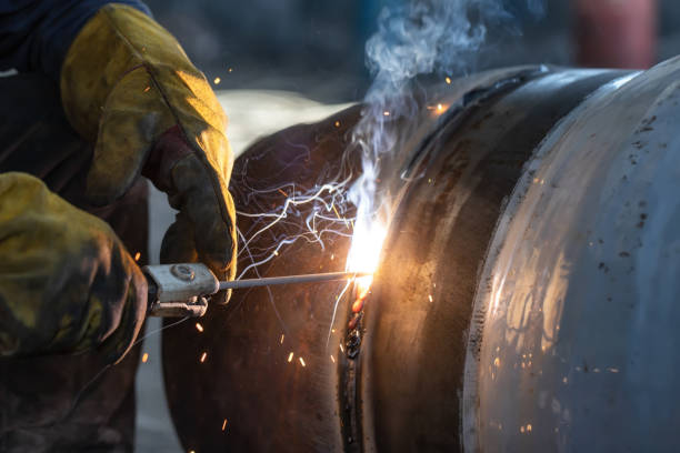 istock Manual arc welding of large diameter pipeline elements 1155859141