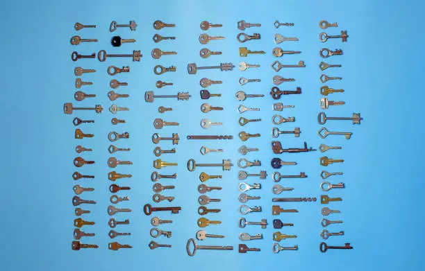 Keys set on blue background. Door lock keys and safes for property security and house protection. Different antique and new types of keys.