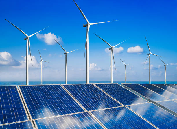 istock Solar panel and wind turbine farm clean energy. 1155861630