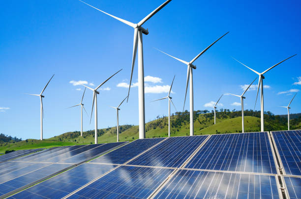 istock Solar panel and wind turbine farm clean energy. 1155861650