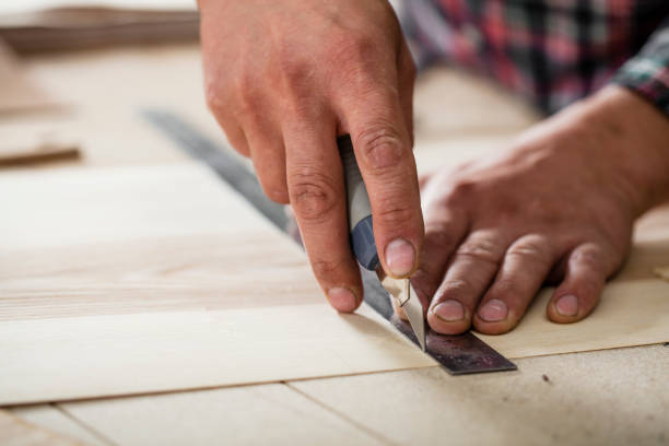 istock hands of a master in a workshop with a ruler and a knife 1155863186