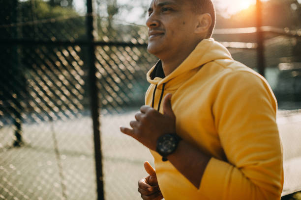 istock One latin man jogging in the park 1155865017