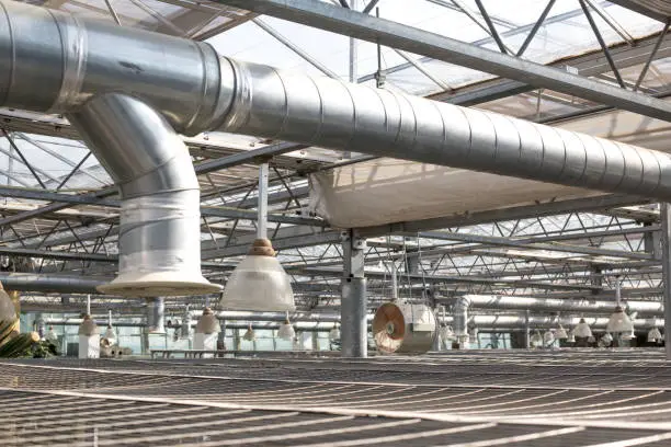 Photo of Air Condition pipe line system with glass ceiling. Ceiling air duct and light