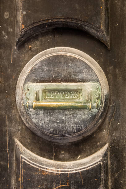 istock Old round letterbox on the house front door 1155869356