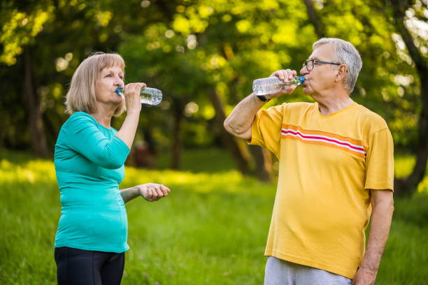 istock Senior couple exercising in park 1155869802