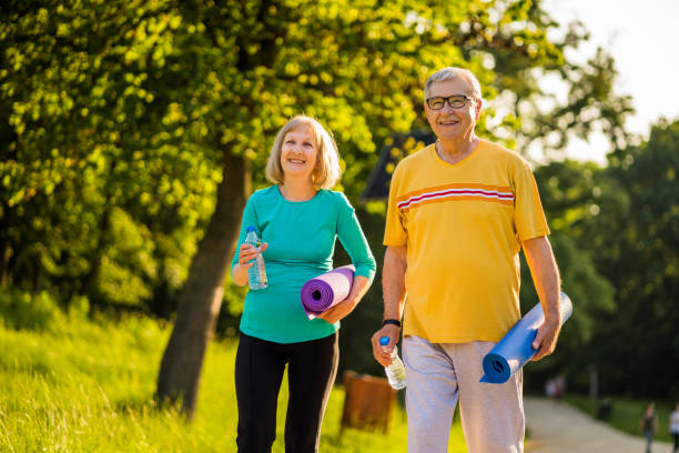 istock Senior couple exercising in park 1155870416