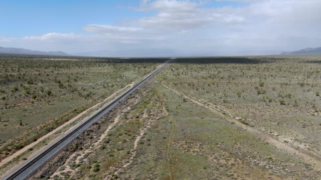 Cargo locomotive railroad engine crossing Arizona desert wilderness