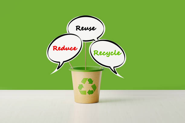 Speech bubbles in a  garbage bin made of recycled paper on green background. Reduce, reuse and recycle words are  wrıtten on the speech bubbles. Horizontal composition with copy space.