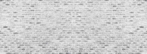 Photo of Wide white washed brick wall texture. Rough light gray brickwork. Whitewashed panoramic vintage background