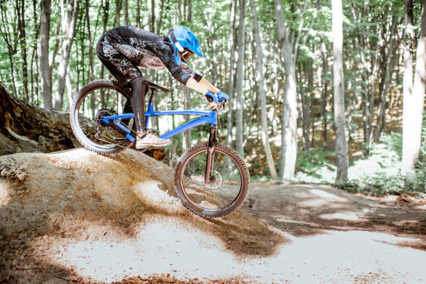 istock Cyclist riding extremely in the forest 1155873328