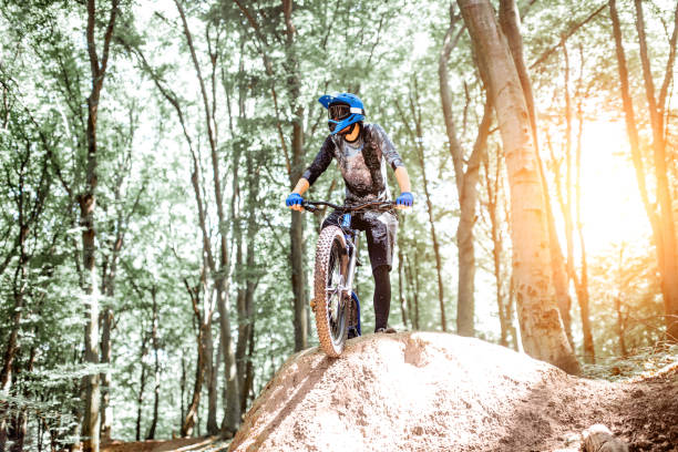 istock Professional cyclist riding in the forest 1155873335