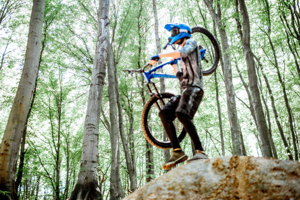 istock Cyclist carrying bicycle while riding extremely in the forest 1155873350