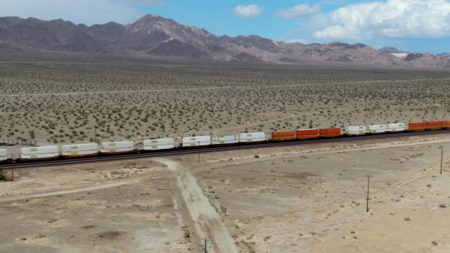 Cargo locomotive railroad engine crossing Arizona desert wilderness