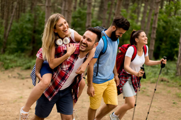 istock Happy young group hiking together through the forest 1155874554