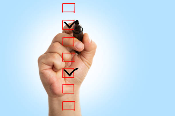istock Closeup of man drawing tick 1155876187