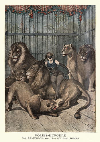 Vintage engraving of Female lion tamer with her lions, Folies Bergere, 19th Century. Countess De X .. and her lions. (Folies Bergere.  La Comtese De X.. et ses lions). The Folies Bergere is a cabaret music hall, located in Paris, France.