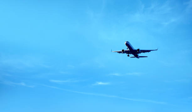 istock flying commercial passenger airplane over blue sky 1155877104