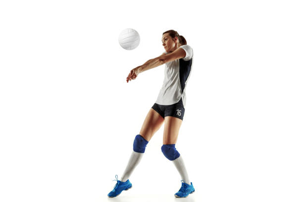 Young female volleyball player isolated on white studio background Young female volleyball player isolated on white studio background. Woman in sport's equipment and shoes or sneakers training and practicing. Concept of sport, healthy lifestyle, motion and movement. volleyball stock pictures, royalty-free photos & images