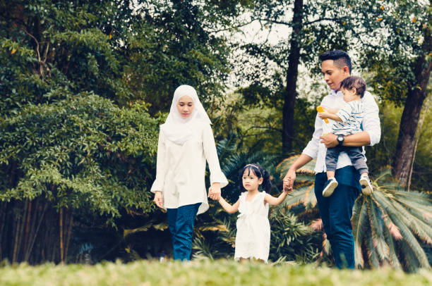 istock Loving Family Walking In Park 1155880028