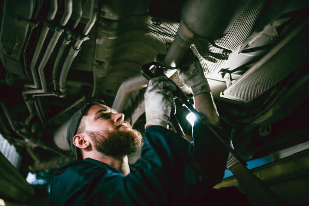 istock Male Mechanic Fixing Car Exhaust System 1155881119