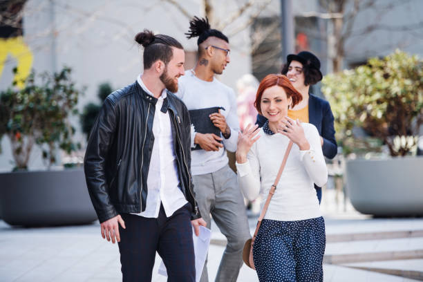 istock Group of young businesspeople walking outdoors in courtyard. 1155881776
