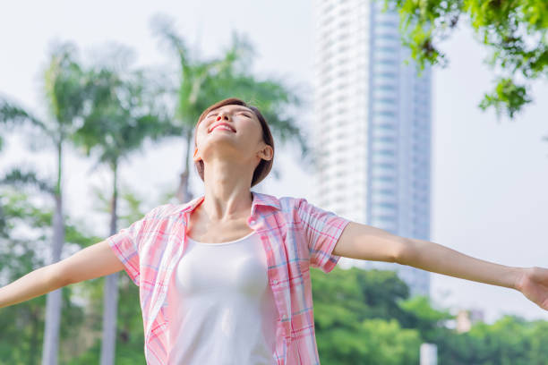 young asian woman stretch her arm and feel carefree