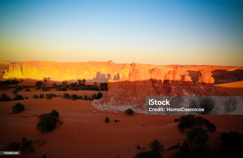 Sunrise at sandstone formation in the Sahara desert near Yoa Lake group of Ounianga Kebir, Ennedi, Chad Sunrise at sandstone formation in the Sahara desert near Yoa Lake group of Ounianga Kebir in Ennedi, Chad Chad - Central Africa Stock Photo