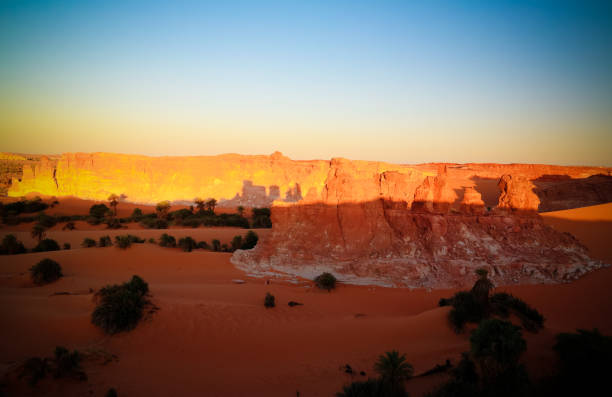 Sunrise at sandstone formation in the Sahara desert near Yoa Lake group of Ounianga Kebir, Ennedi, Chad Sunrise at sandstone formation in the Sahara desert near Yoa Lake group of Ounianga Kebir in Ennedi, Chad ennedi massif photos stock pictures, royalty-free photos & images