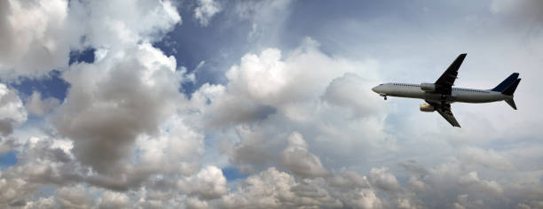 istock flying commercial passenger airplane over cloudy storm sky 1155882369
