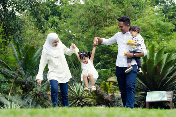 istock Loving Family Walking In Park 1155883653