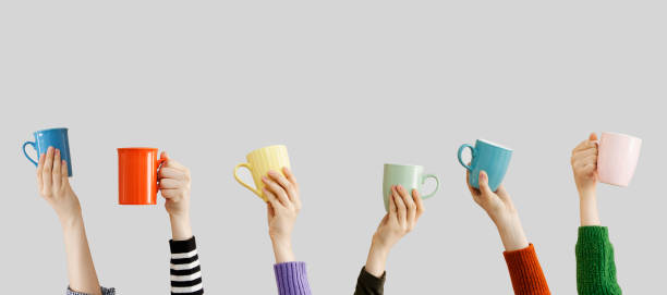 istock Many different arms raised up holding coffee cup 1155884626