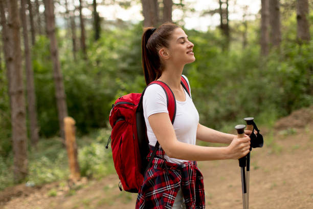 istock Young woman hiking on forest track 1155893242