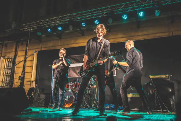 Young music band performing at rock concert