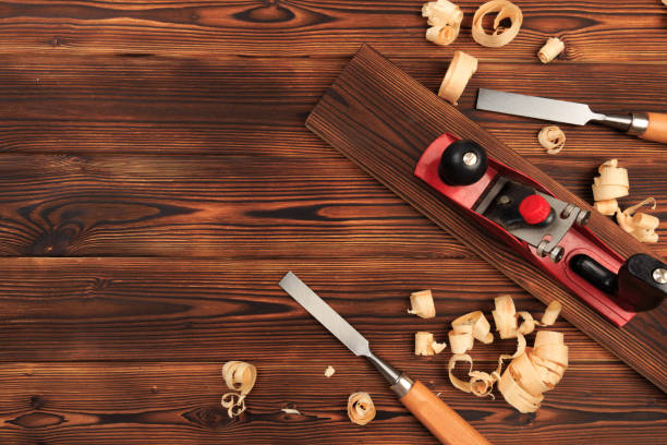chisels plane and sawdust on a wooden table - Image