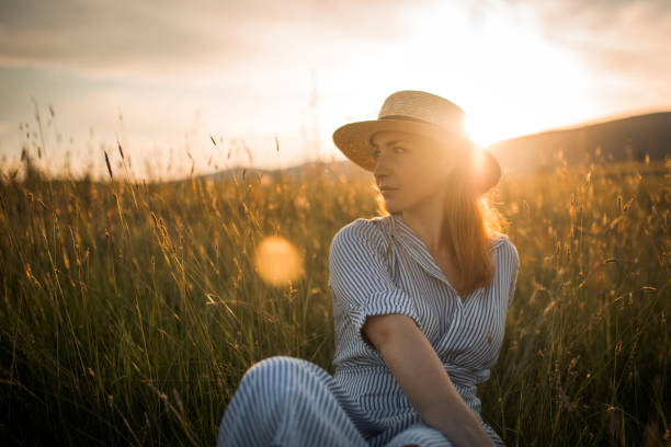 Young Woman Wearing Hat Standing On Land