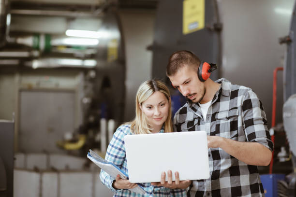 istock Young Technicians are Inspecting Heating System in Boiler Room 1155896653