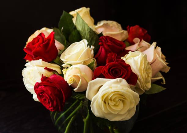 istock Bouquet of red and white roses on a black background 1155898055