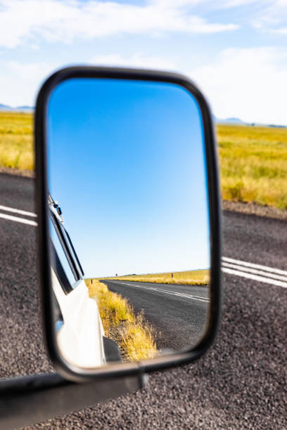 istock Reflection in a side mirror of a country road 1155901064
