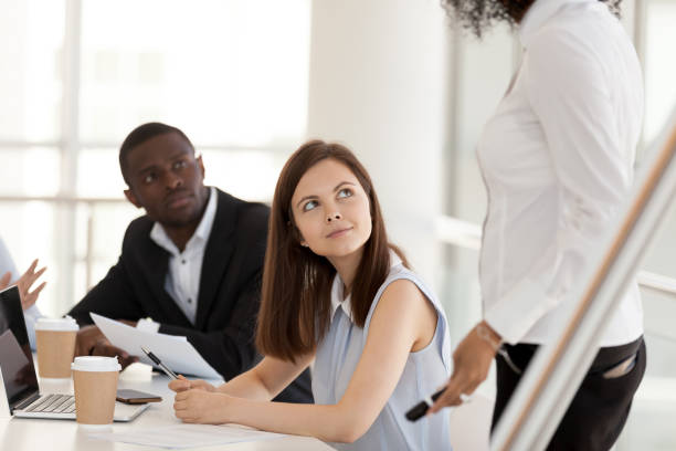 jonge vrouwelijke werknemer te kijken naar business coach bij bedrijf meeting - gesprek coaching detail stockfoto's en -beelden
