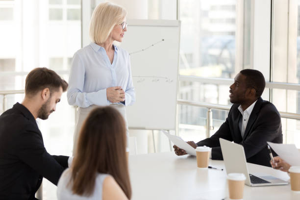istock African American employee ask question to middle-aged coach, boss 1155902155