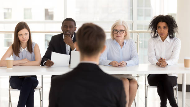 istock Diverse HR managers listen to applicant answering questions rear view 1155902282