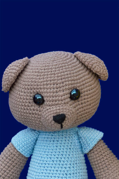 istock Teddy bear doll on a blue background at the fair 1155903337