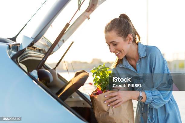 Happy Girl Packing Groceries Stock Photo - Download Image Now - Supermarket, Groceries, Car