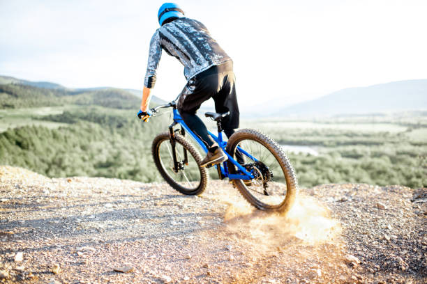 istock Cyclist riding on the rocky mountains 1155903346