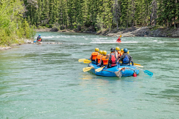 Rafting on the Kananaskis River Kananaskis Provincial Park, Alberta, Canada - June 11, 2019:  a group of whitewater rafters travel through rapids on the Kananaskis River kananaskis country stock pictures, royalty-free photos & images